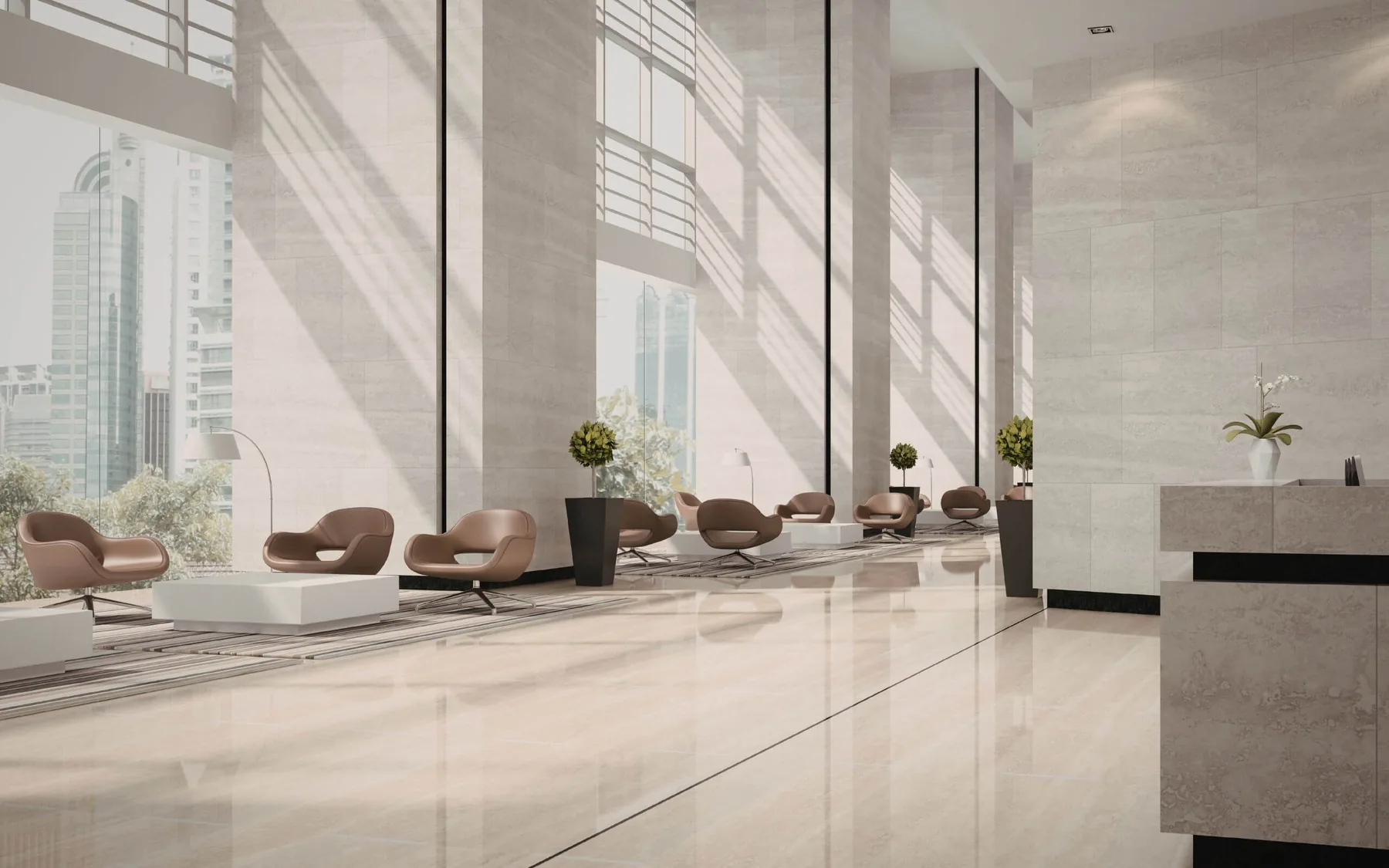Sunlit commercial building lobby with seating and full-height glazing