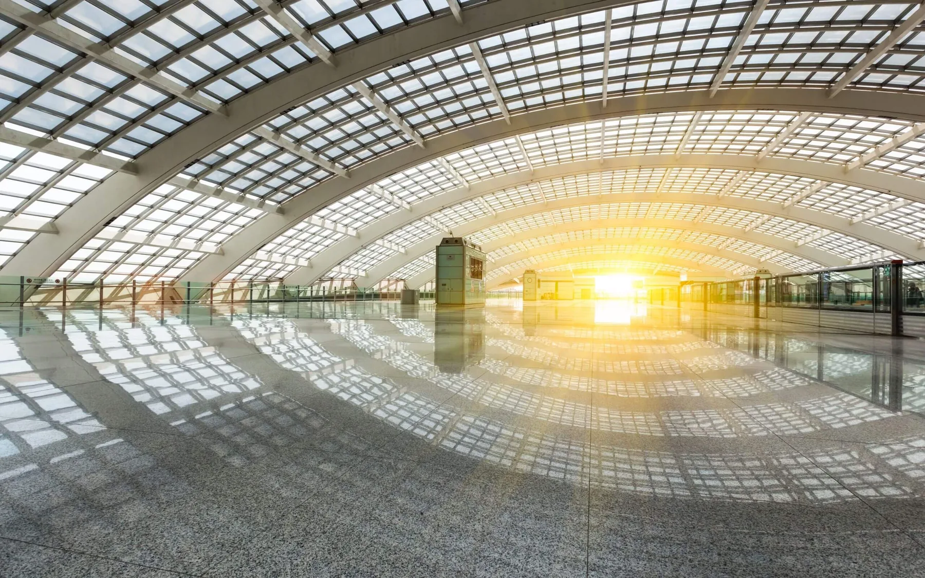 Vaulted glazed atrium filled with late daylight